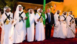 President Donald Trump poses for photos with ceremonial swordsme