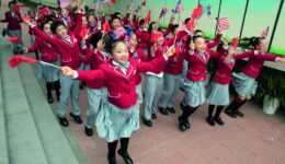 Chinese students wave U.S. and Chinese flags as they send off U.S. first lady Melania Trump and Chinese first lady Peng Liyuan after their visit to the Banchang Primary School in Beijing