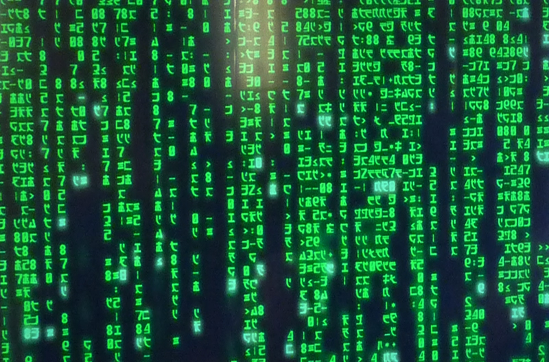 Códigos em verde que simulariam a realidade no filme 'Matrix' em fundo preto.