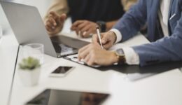 Office workers checking papers with pen in office