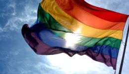 Rainbow_flag_and_blue_skies
