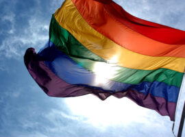Rainbow_flag_and_blue_skies